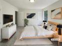 Staged main bedroom featuring neutral walls, modern decor, and plush bedding at 1950 Matthew Way, Lithonia, GA 30058
