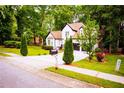 Beautifully landscaped front yard featuring lush greenery and a long driveway at 6147 Pritchett Dr, Powder Springs, GA 30127