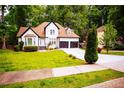Inviting home with a well-maintained lawn, lovely landscaping, and a two-car garage at 6147 Pritchett Dr, Powder Springs, GA 30127