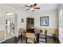 Cozy dining room with wainscoting, a ceiling fan, and space for a round table at 682 Leighton Way, Stone Mountain, GA 30088