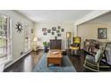 Bright living room with large windows, hardwood floors, and comfortable seating arrangement at 682 Leighton Way, Stone Mountain, GA 30088