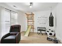 Versatile room featuring recreational equipment, comfortable chair, and bright light from large windows at 321 Hickory Sw Walk, Marietta, GA 30064