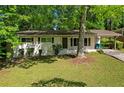 Quaint single-story home with a well-maintained lawn and mature trees creating a serene setting at 2740 Pasco Se Ln, Atlanta, GA 30316