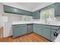 Open concept kitchen features stainless dishwasher, wood floors, and ample cabinet space at 2740 Pasco Se Ln, Atlanta, GA 30316