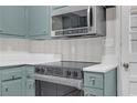 A renovated kitchen features new stainless appliances, updated counters and bead board backsplash at 2740 Pasco Se Ln, Atlanta, GA 30316