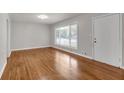 Sunlit living room featuring beautiful hardwood floors, a large window, and a freshly painted interior at 2740 Pasco Se Ln, Atlanta, GA 30316