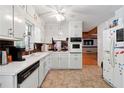 Traditional kitchen with white cabinets and updated stainless steel appliances offer lots of storage at 2944 Williams Pl, Snellville, GA 30078