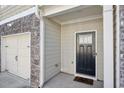 Front door with a black door and stone and brick accent at 5853 Greystone Dr, Lithonia, GA 30058