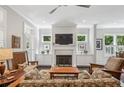 Cozy living room with fireplace, built-in cabinets, and comfortable seating area at 613 Brennan Dr, Decatur, GA 30033