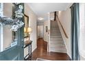 Inviting foyer featuring hardwood floors, a staircase, and natural light at 661 Village Field Nw Ct, Suwanee, GA 30024