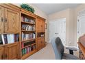 Cozy office featuring custom built-ins, natural light, and comfortable seating at 661 Village Field Nw Ct, Suwanee, GA 30024