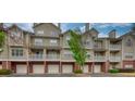 Exterior view of condo building featuring multiple units with balconies and attached garages at 3107 Woodland Ln, Alpharetta, GA 30009