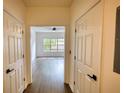 Hallway showcasing hardwood floors and access to the main living area with natural light at 3107 Woodland Ln, Alpharetta, GA 30009