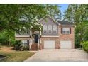 Charming two-story home with brick and gray siding, attached two-car garage, landscaped lawn and mature shade trees at 3607 Anna Nw Ln, Kennesaw, GA 30144