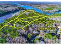 Aerial view of homes near lake with hiking trails and lake access shown via yellow lines at 1336 Amberwood Dr, Woodstock, GA 30189