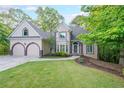 Beautiful home with manicured lawn, two-car garage, and a welcoming front entrance at 1336 Amberwood Dr, Woodstock, GA 30189