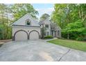 Inviting home with well-maintained lawn, spacious driveway, and a classic facade at 1336 Amberwood Dr, Woodstock, GA 30189