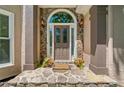 Inviting entryway with stone accents, potted plants, and a decorative welcome mat for added curb appeal at 1336 Amberwood Dr, Woodstock, GA 30189