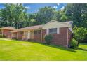 Charming brick ranch home on a large lot with mature trees and green grass at 2311 Cherry Blossom Sw Dr, Atlanta, GA 30331