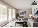 Staged living room featuring french doors, neutral paint, and modern decor at 2311 Cherry Blossom Sw Dr, Atlanta, GA 30331