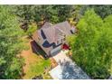 Aerial view of a two-story home with lush green surroundings and a long driveway at 3095 Willow Park Dr, Dacula, GA 30019