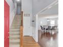 Inviting foyer featuring hardwood floors, a staircase, and an open view to the dining area at 3095 Willow Park Dr, Dacula, GA 30019