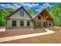 Inviting craftsman home showcasing a well-manicured lawn, covered front porch, and rustic architectural features at 60 Browning Shoals Rd, Social Circle, GA 30025