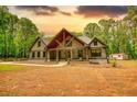 Picturesque craftsman-style home with a beautiful lawn and a covered front porch, complemented by lush greenery at 60 Browning Shoals Rd, Social Circle, GA 30025