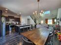 Modern kitchen featuring an island with seating, stainless appliances, and wood floors at 1132 Red Bud Cir, Villa Rica, GA 30180