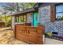 Up close shot of the gray brick exterior and teal door of this cozy home at 1554 Cardinal Rd, Jonesboro, GA 30238