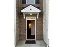 Inviting front door with brick accents and a covered entryway that leads into a bright home at 1938 Dilcrest Dr, Duluth, GA 30096