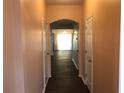 Hallway showcasing smooth walls and dark wood floors that lead to the main living areas at 1938 Dilcrest Dr, Duluth, GA 30096