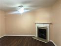 Cozy living room featuring a classic fireplace, modern ceiling fan, and beautiful flooring at 1938 Dilcrest Dr, Duluth, GA 30096