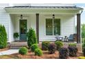 Inviting front porch with seating, landscaping, and stylish exterior lighting at 2201 Old Dallas Sw Rd, Marietta, GA 30064