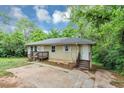 Cozy one-level home boasts a timeless appeal and a neatly maintained front yard at 2952 Mcafee Rd, Decatur, GA 30032