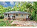 Inviting single-story house with traditional architecture, set against a backdrop of lush greenery at 2952 Mcafee Rd, Decatur, GA 30032