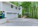 Spacious two car garage with additional parking on a newly paved drive, surrounded by mature trees at 3460 Wycherly Ne Ct, Brookhaven, GA 30319