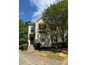 Charming two-story townhome with a well-manicured lawn, complemented by mature trees and a blue sky backdrop at 3650 Deep Cove Dr, Cumming, GA 30041