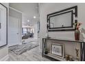 Bright entryway featuring wood-look floors, decorative console table, and an open view into the living area at 130 Maple Creek Way, Woodstock, GA 30188