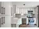 Modern kitchen features stainless appliances, subway tile backsplash, and white cabinets at 2302 Colonial Ne Dr, Brookhaven, GA 30319