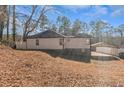 View of the back exterior with a carport and spacious yard, perfect for outdoor entertaining at 4175 Danforth Sw Rd, Atlanta, GA 30331