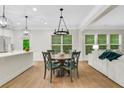 Open-concept dining area with stylish lighting, seamlessly connected to the modern kitchen at 4240 Spring Ridge Dr, Cumming, GA 30028