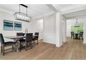 Elegant dining room featuring modern lighting, stylish decor, and a view into another dining space at 4240 Spring Ridge Dr, Cumming, GA 30028