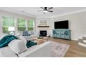 Comfortable living room with fireplace and modern furnishings, filled with natural light at 4240 Spring Ridge Dr, Cumming, GA 30028