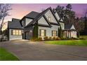 Charming two-story home featuring a long driveway and a three car garage, set on a well-manicured lawn at 4370 Freys Farm Nw Ln, Kennesaw, GA 30152