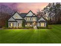Charming two-story home featuring a manicured lawn with verdant landscaping and elegant architectural details at 4370 Freys Farm Nw Ln, Kennesaw, GA 30152