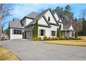 Charming two-story home with landscaped yard, grey brick facade, and a spacious driveway leading to a two-car garage at 4370 Freys Farm Nw Ln, Kennesaw, GA 30152