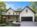 Beautiful two-story home with a spacious driveway, attached garage, and inviting front porch at 4614 Riveredge Cv, Snellville, GA 30039