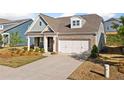 Delightful home boasts a combination brick and siding exterior, a neat lawn, and an attached two-car garage at 503 Forest Ln, Canton, GA 30114