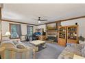 Cozy living room with a brick fireplace, ceiling fan, and neutral-toned furnishings at 3876 Winners Ct, Marietta, GA 30062